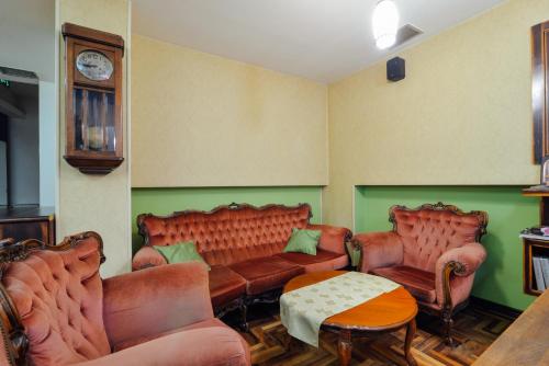 a waiting room with leather couches and a table at Hotel Mod in Sarajevo