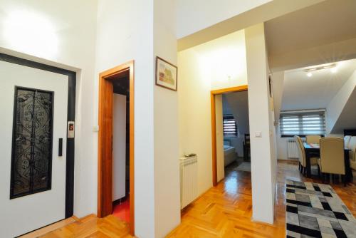 a hallway with a dining room and a dining table at Hotel Mod in Sarajevo