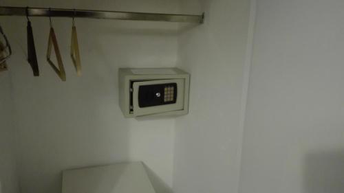 a bathroom with a microwave on a wall at Hotel Caribe in Mar del Plata