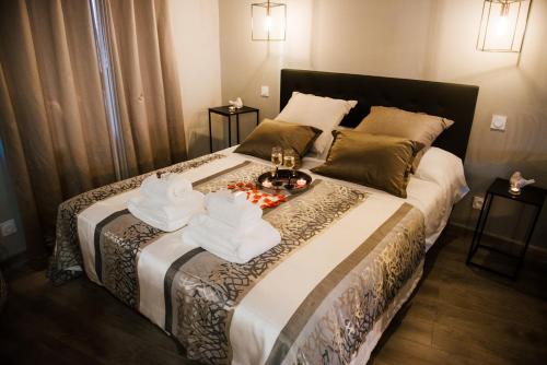 a hotel room with a bed with towels on it at La Suite Romantique avec Jacuzzi au Cœur de Perpignan in Perpignan