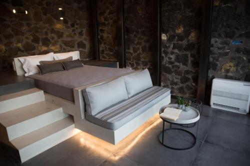 a bedroom with a bed and a table in a room at Horizon Mills in Imerovigli