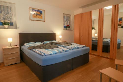 a bedroom with a bed with blue sheets on it at Haus Sonnenschein in Witten