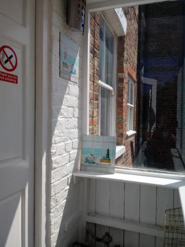 a window with a box sitting on a window sill at Belle Vue Bridlington in Bridlington