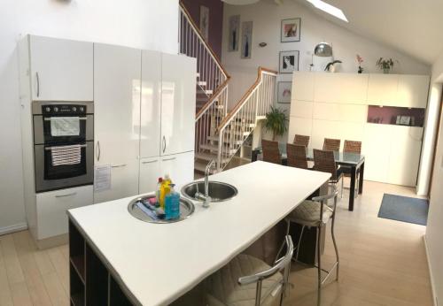 a kitchen with a island with a sink in it at Modern City Centre House in Galway