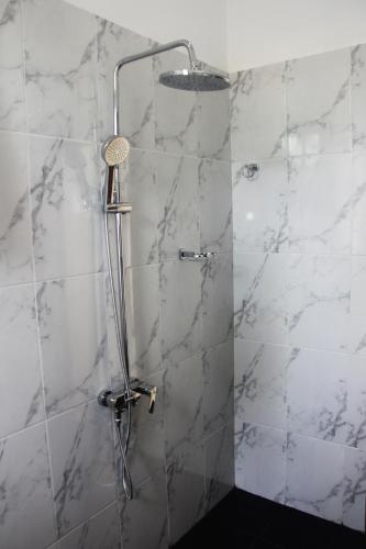 a shower with a glass door in a bathroom at Ever Green Villa in Negombo