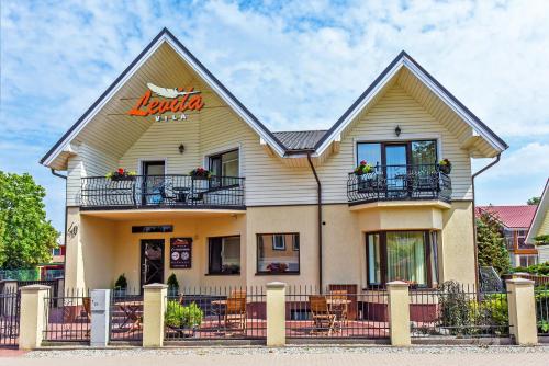 a building with a restaurant on the side of it at Vila Levita in Palanga