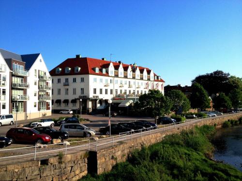 a bridge with cars parked in a parking lot next to buildings at Grand Hotel Falkenberg in Falkenberg