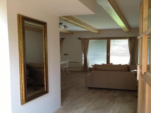a living room with a couch and a mirror at Apartments Vila Cvetka Bled in Bled