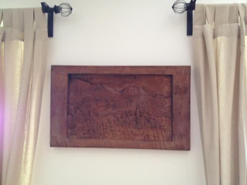 a picture hanging on a wall with curtains at Apartments Vila Cvetka Bled in Bled