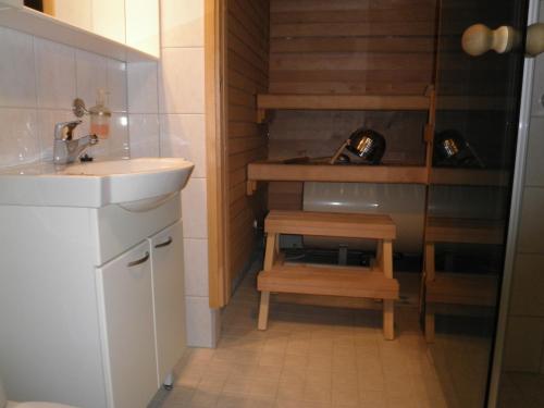 a small bathroom with a sink and a staircase at Yllästar 305 Apartment in Äkäslompolo