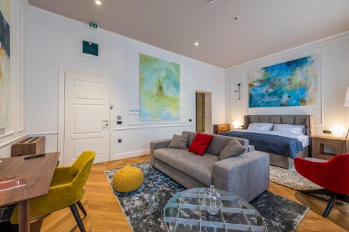 a living room with a couch and a bed at Boutique hotel Tvrđa in Osijek