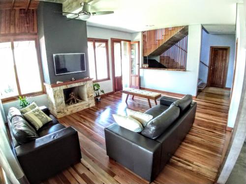 a living room with a couch and a fireplace at Refúgio 755 in Florianópolis