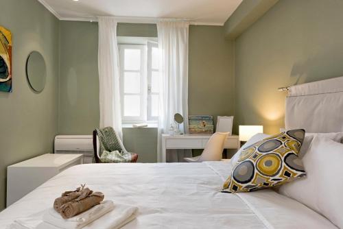 a bedroom with a large bed with towels on it at Artemis Apartment in Corfu Town
