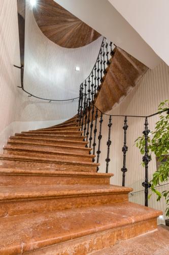 a set of stairs in a building with a ceiling at Boutique hotel Tvrđa in Osijek