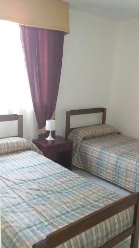 Postel nebo postele na pokoji v ubytování Apart Antofagasta