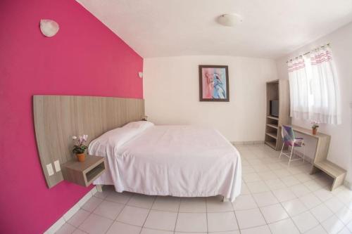 A bed or beds in a room at Hotel Santa Cruz Juchitan