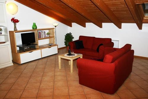 a living room with a red couch and a tv at Residence Bizzoni in Terni