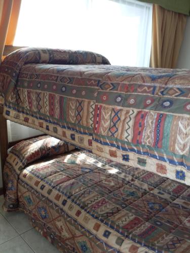 two ottomans sitting on top of a couch at Apart Antofagasta in Antofagasta