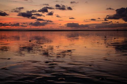 a sunset over a body of water at Hotel Costa Choco in Bahía Solano