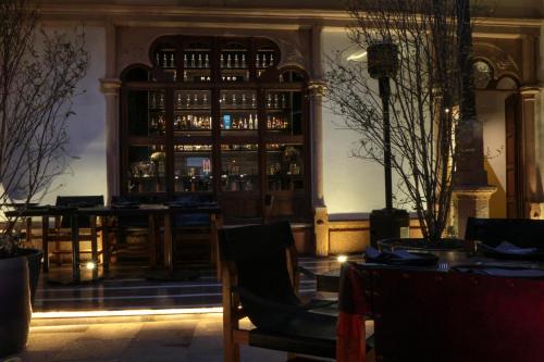 a bar in a restaurant with tables and chairs at Elena de Cobre, Leon, a Member of Design Hotels in León