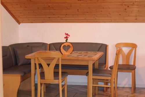 a dining room table and chairs with a couch at Meisenthaler Mühle in Kelberg