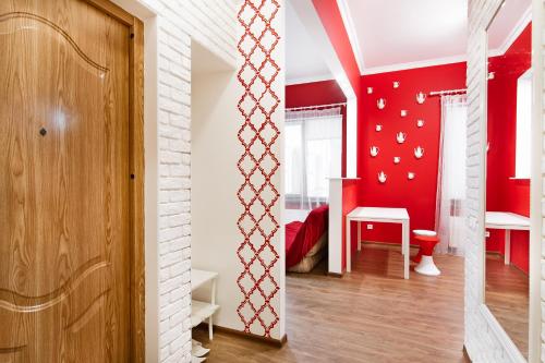 a room with red and white walls and a door at Modern Apartment in the city center in a new building in Odesa