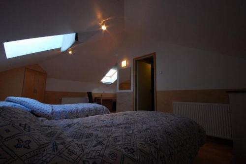 a bedroom with two beds and a large window at Piibutopsu Holiday House in Nasva