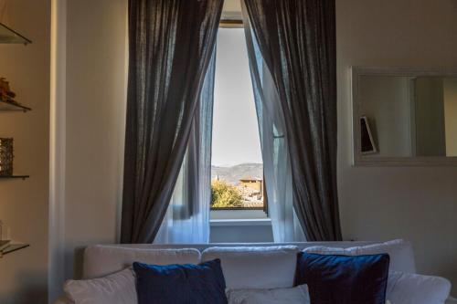 a living room with a couch and a large window at White House in Orvieto