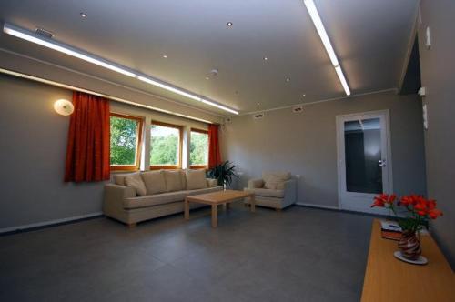 a large living room with couches and a tv at Piibutopsu Holiday House in Nasva