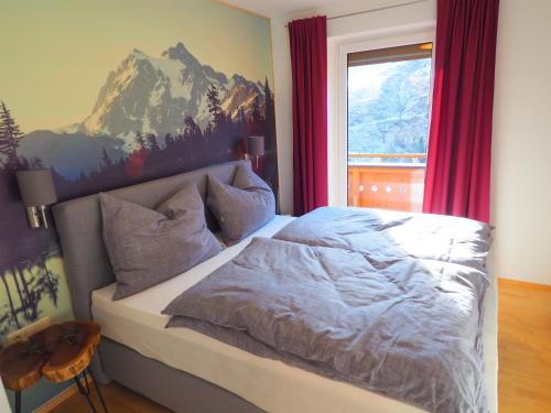 a bedroom with a bed and a window with red curtains at MarieindenBergen - Ihre private Unterkunft in Saalbach-Hinterglemm