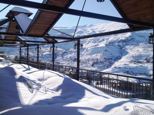 a snowboard ramp with a view of a mountain at Hotel Chbat in Bcharré