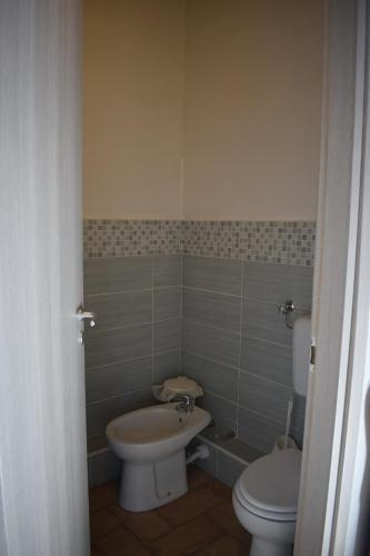 a bathroom with a toilet and a sink at Villa Storica Calderino in Monte San Pietro