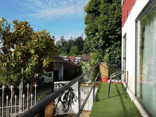a balcony with green grass on a house at Hostal Vivo Concepción in Concepción