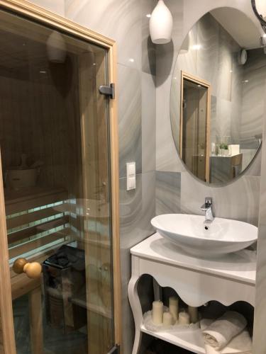 a bathroom with a sink and a mirror at Family & Business Sauna Apartments No2 Leśny nad Zalewem Cedzyna - 2 Bedroom with Private Sauna, Bath with Hydromassage, Terrace, Parking, Catering Options in Kielce
