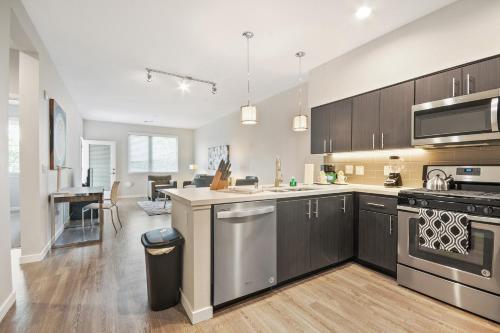 a kitchen with stainless steel appliances and a living room at Global Luxury Suites in Menlo Park in Menlo Park