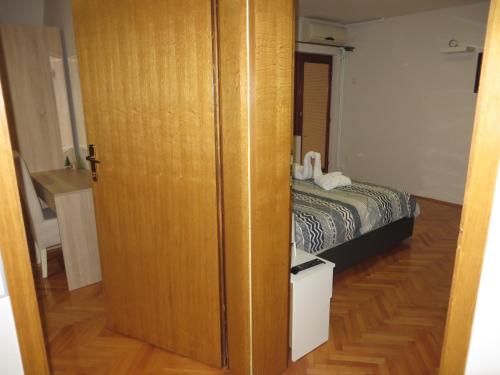 a door leading to a bedroom with a bed at Leo in Niš
