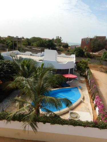 a resort with a swimming pool and a palm tree at Residence Saint James in Somone