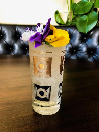 a glass vase with flowers in it on a table at Jupiter NEXT in Portland