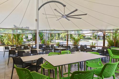 a restaurant with tables and chairs under a white tent at Ingenia Holidays Cairns Coconut in Cairns