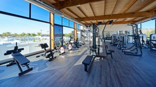 a gym with a lot of treadmills and ellipticals at Club Maspalomas Suites & Spa - Adults Only in Maspalomas