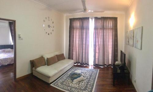 a living room with a couch and a window at Putrajaya 1808 Homestay in Putrajaya