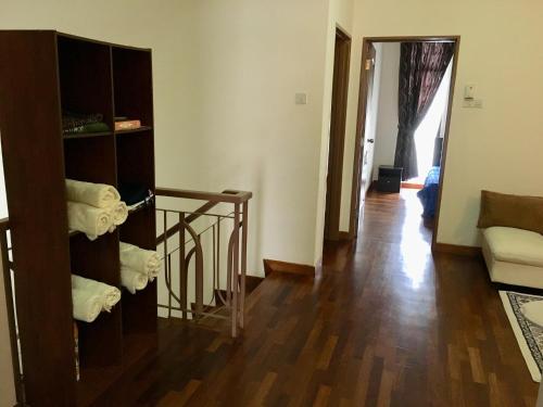 a living room with a staircase and a living room with a room at Putrajaya 1808 Homestay in Putrajaya