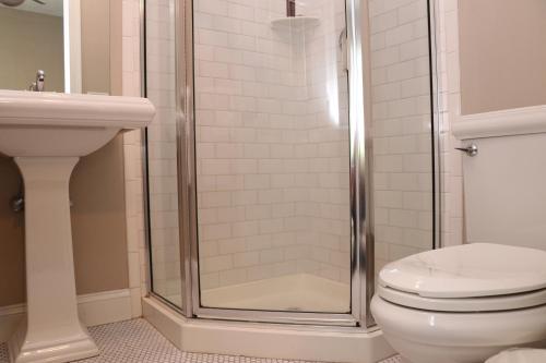 a bathroom with a shower with a toilet and a sink at Furnished Studio in Downtown Boston #35 in Boston
