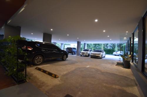 a parking lot with cars parked in a garage at B Boutique Residence in Suratthani