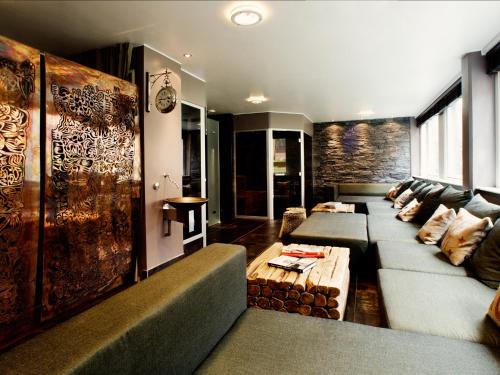 a living room with a couch and a table at Varbergs Stadshotell & Asia Spa in Varberg