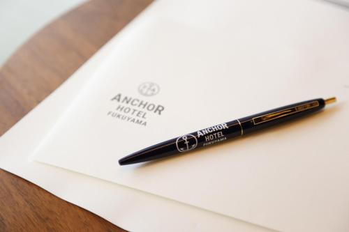 a pen sitting on top of a piece of paper at Anchor Hotel Fukuyama in Fukuyama