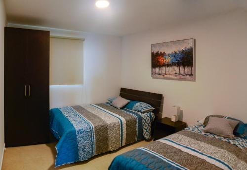 Una cama o camas en una habitación de Lindo Departamento al pie de playa Edificio TORRE OCEÁNICA