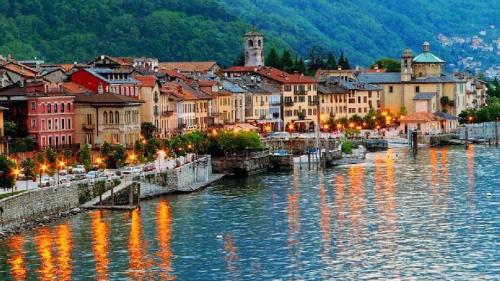 a town next to a body of water with buildings at Hotel Casa Arizzoli in Cannobio