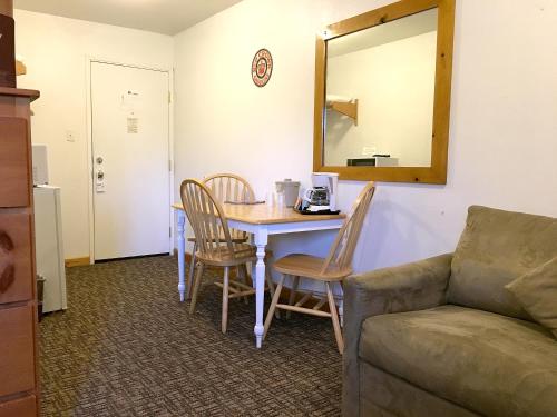 a living room with a table and chairs and a couch at Park Motel and Cabins in Florence