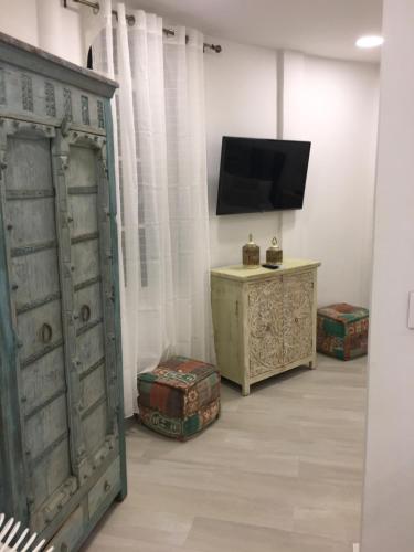a room with an old door and a television at Le Castel Blanc Hotel Boutique in San Andrés